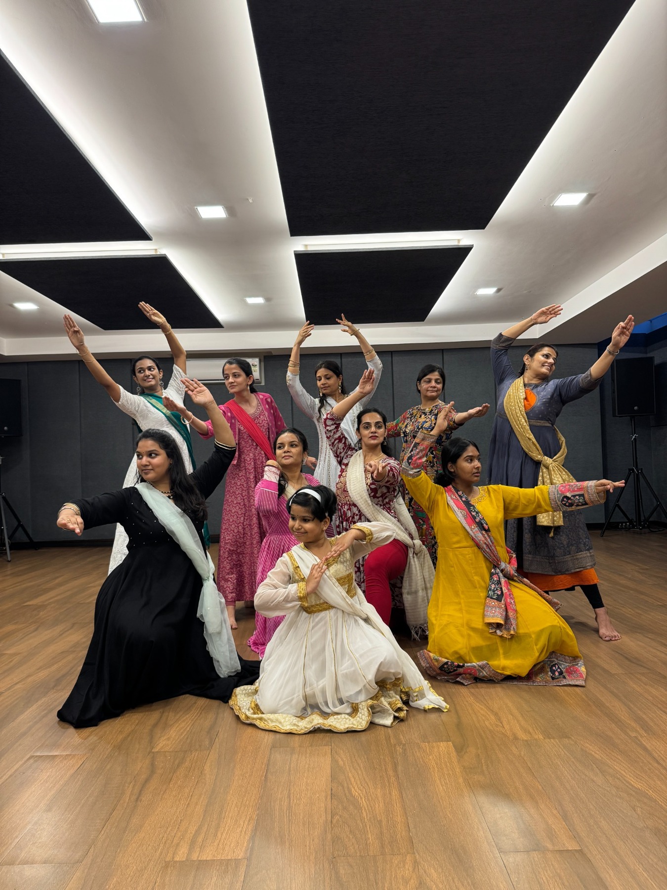 Kathak dancers posing together in the studio.
